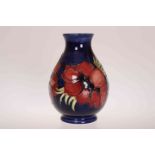 A MOORCROFT POTTERY ANEMONE VASE, of ovoid form with blue ground.