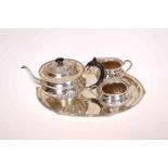 AN INDIAN WHITE METAL TEA SERVICE, comprising teapot, cream jug,