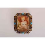 AN EARLY 19TH CENTURY MINIATURE OF A CHILD, watercolour set in a cabochon amethyst,