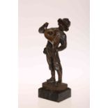 A GERMAN PATINATED BRONZE, "KUNST-PAUSE", cast as a boy holding a horn, cast by Gladenbeck, Berlin,