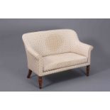 A VICTORIAN OAK AND UPHOLSTERED SETTEE OF SMALL PROPORTIONS, with out-scrolled arms,