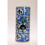 AN IZNIK POTTERY VASE, cylindrical, painted with foliage. 20.