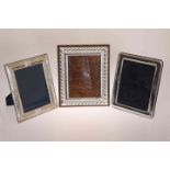 THREE SILVER PICTURE FRAMES, modern, of rectangular easel form. (3) Largest 27.5cm by 22.