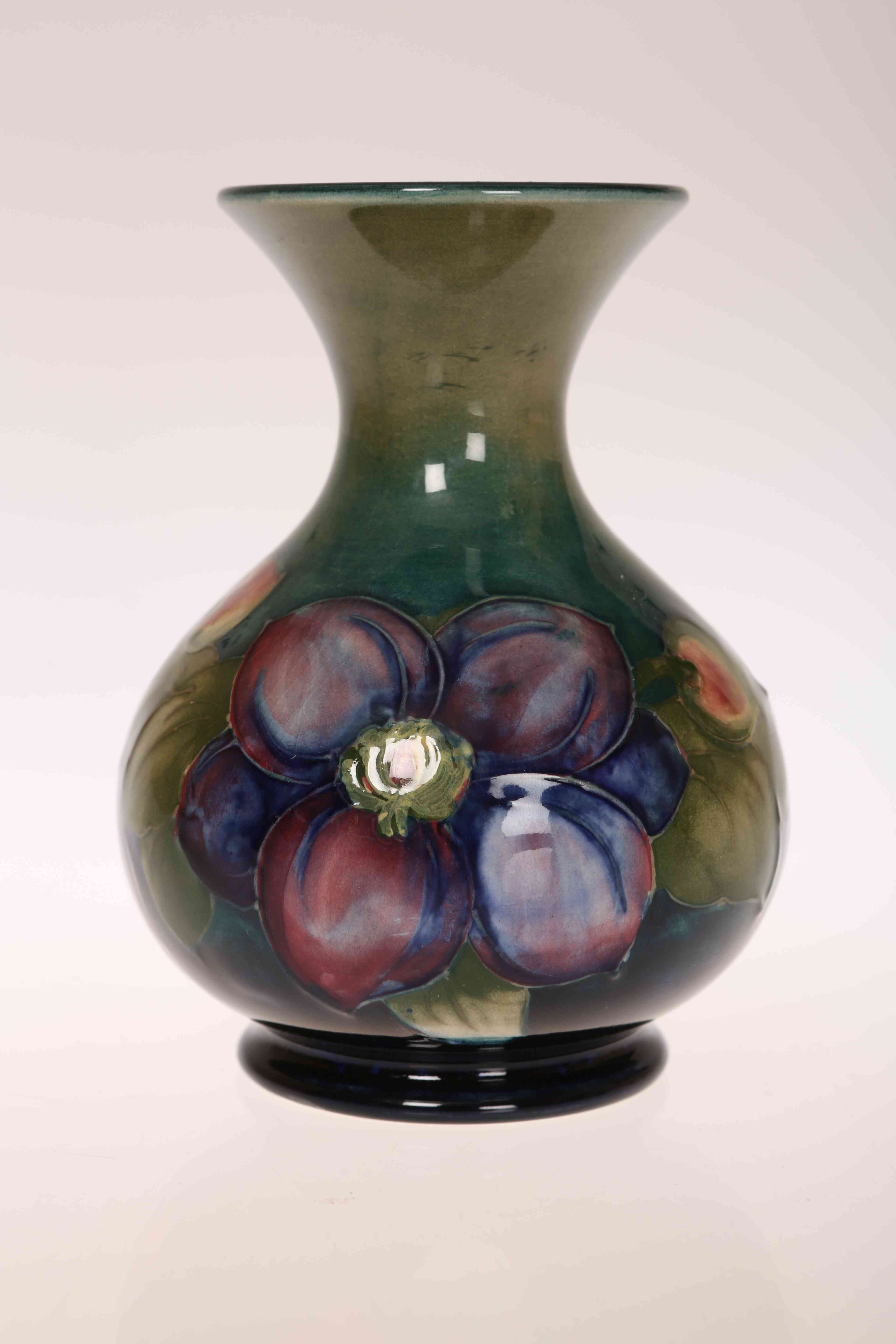 A MOORCROFT POTTERY VASE, tubelined and hand painted with Clematis,