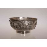 A CHINESE SILVER BOWL, of circular form with embossed dragon on a hammered ground. Diameter 11.