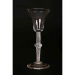 A WINE GLASS WITH DOUBLE OGEE BOWL, multiple spiral air twist stem with central swelling knop,