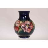 A LARGE MOORCROFT POTTERY ANEMONE VASE, of bulbous form, signed in blue on base.