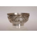 A CHINESE SILVER BOWL, of circular form with embossed dragon on a hammered ground. Diameter 11.