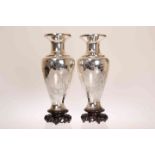 A PAIR OF CHINESE SILVER VASES, of shouldered ovoid form, engraved with figures holding a scroll,