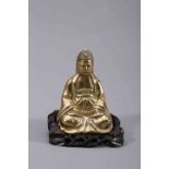 A CHINESE BRASS BUDDHA, 18th/19th Century, with a pierced and carved wood stand.