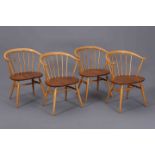 A SET OF FOUR 1960'S ERCOL ELM COW HORN CHAIRS, with spindled bow backs and splayed legs.