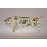 A WEDGWOOD MODEL OF A BULL, designed by Arnold Machin and decorated with flowers and foliage,