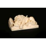 A 19TH CENTURY CARVED IVORY OF THE LION OF LUCERNE, on a rectangular base. 6.