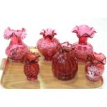 Six cranberry glass vases