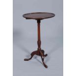 A GEORGE III MAHOGANY TILT-TOP TRIPOD TABLE, the circular dished top with moulded edge,