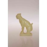 A CHINESE CARVED YELLOW JADE MODEL OF A DOG, seated on a rectangular plinth. 6.