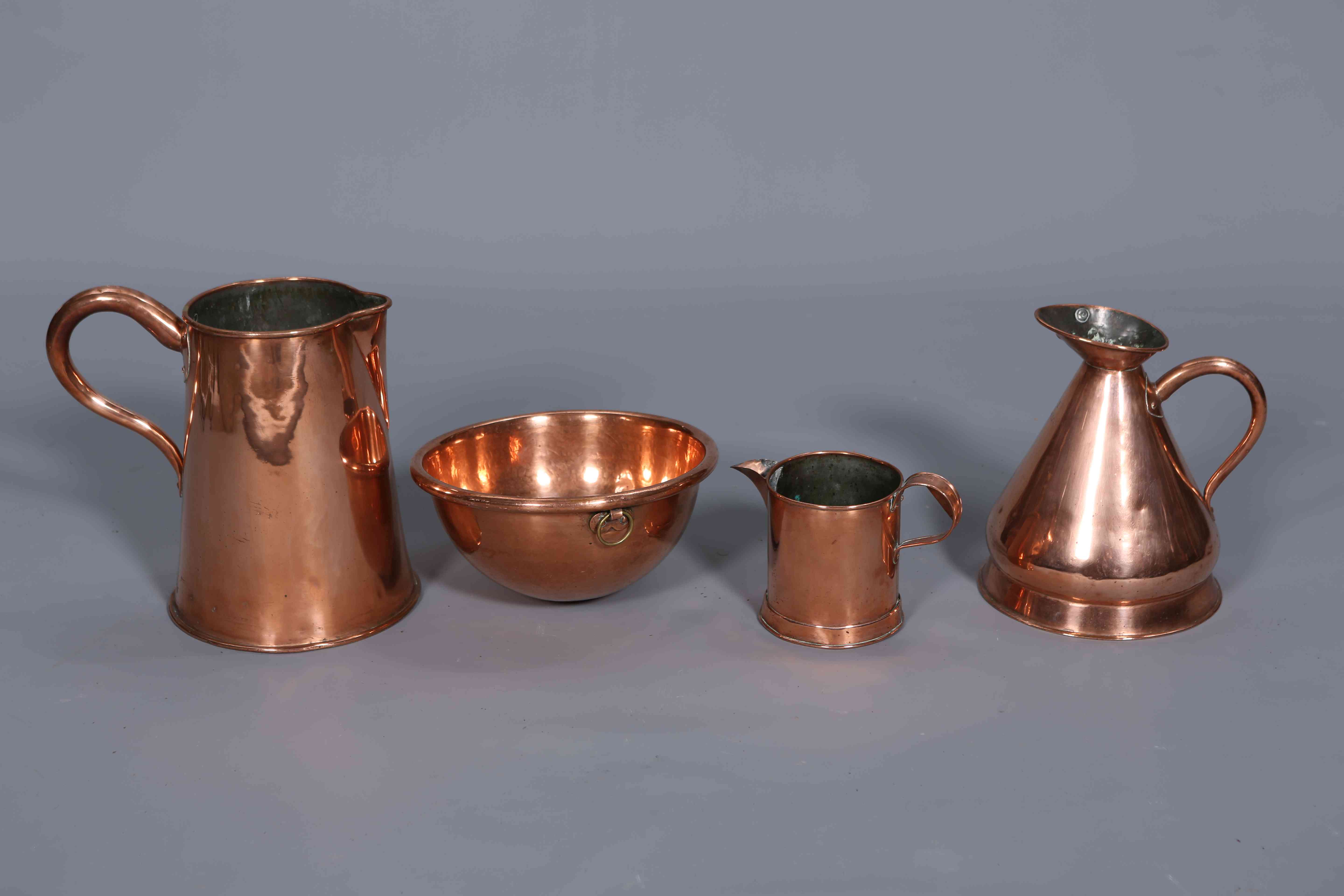 A GROUP OF COPPER ITEMS, comprising three jugs and a bowl.