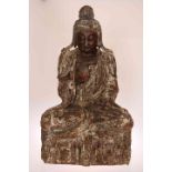 A LARGE TIBETAN CARVED AND POLYCHROME BUDDHA, with remnants of old paint.