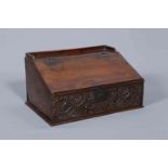 A 17TH CENTURY OAK BIBLE BOX, with hinged slope and carved front with initials B.P.