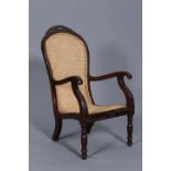 A COLONIAL CARVED TEAK AND CANEWORK PLANTATION CHAIR, 19TH CENTURY,