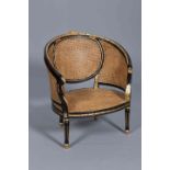 A FRENCH PARCEL GILT, EBONISED AND CANEWORK BERGERE, in Empire style,