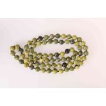 A JADEITE BEAD NECKLACE, the seventy five slightly graduating jadeite beads strung knotted.