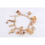 A YELLOW GOLD CHARM BRACELET,