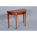A GEORGE III MAHOGANY AND SATINWOOD DEMILUNE FOLDOVER CARD TABLE, the crossbanded,