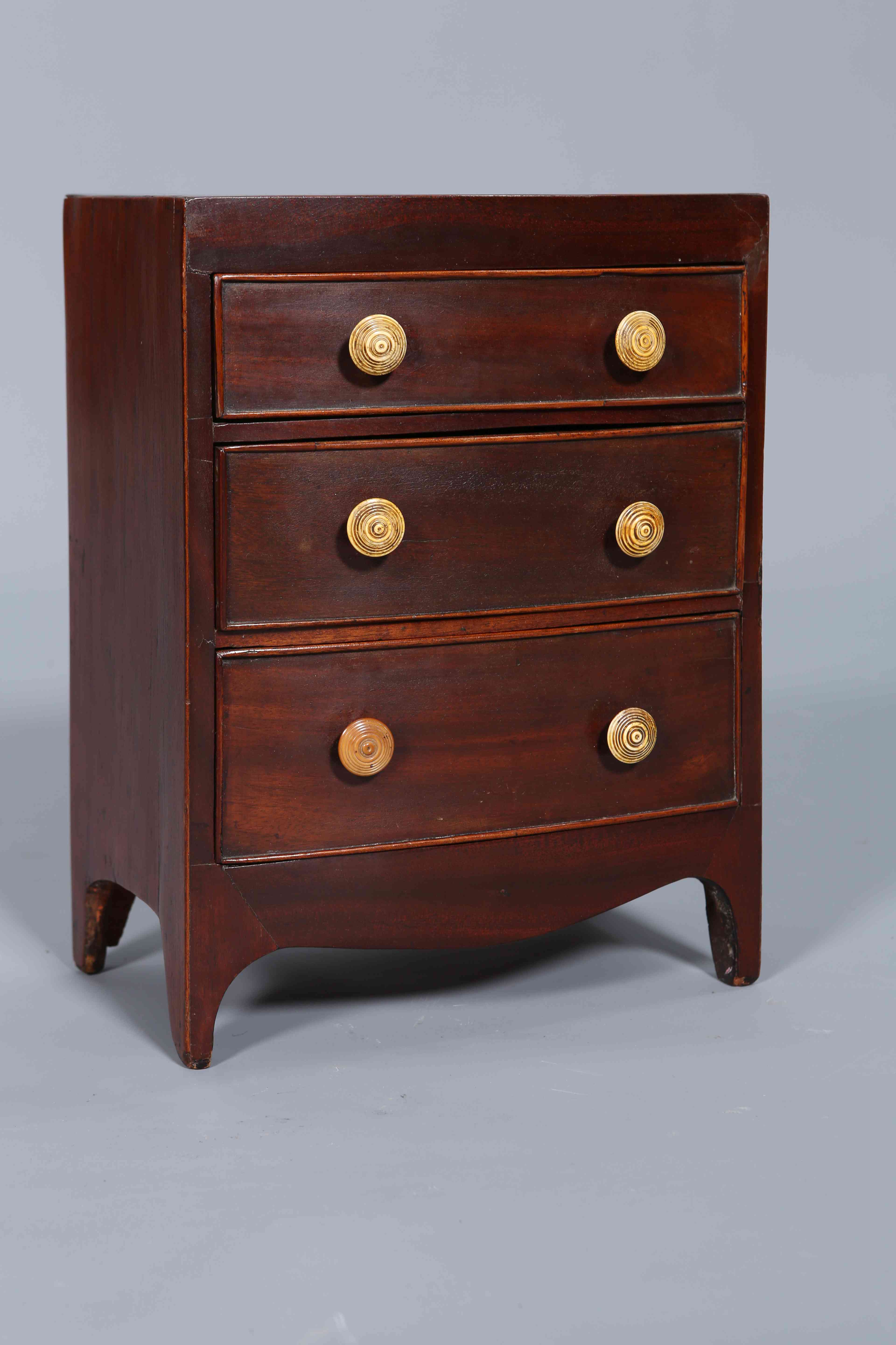 A 19TH CENTURY MAHOGANY MINIATURE CHEST OF DRAWERS, bow-fronted,
