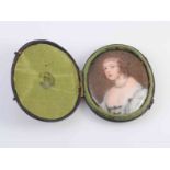 A PORTRAIT MINIATURE OF A LADY IN LATE 17TH CENTURY DRESS, painted enamel,