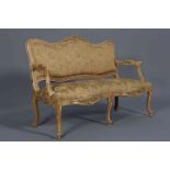 A FRENCH CANAPE, the painted frame with foliate moulded crest and serpentine seat rail,