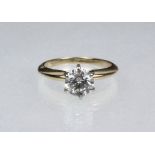 LADY'S RING - One 14K two-tone Tiffany style solitaire engagement ring. Set with (1) round brilliant