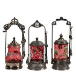 (3) VICTORIAN SILVER PLATE PICKLE CASTORS - Singles with cranberry thumb print glass jars having