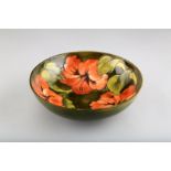 Large Moorcroft pottery fruit bowl, green ground decorated with hibiscus flowers. 26cm diameter 8.