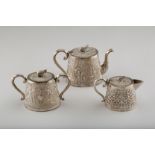 19th / 20th Century three piece Burmese silver tea service including a teapot, sugar basin and cover