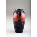 Moorcroft pottery vase, baluster form, pomegranate pattern incised Moorcroft signed to base, 19cm