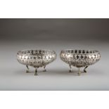 Pair silver pierced bon-bon baskets, circular form, raised on three paw feet, assay marked