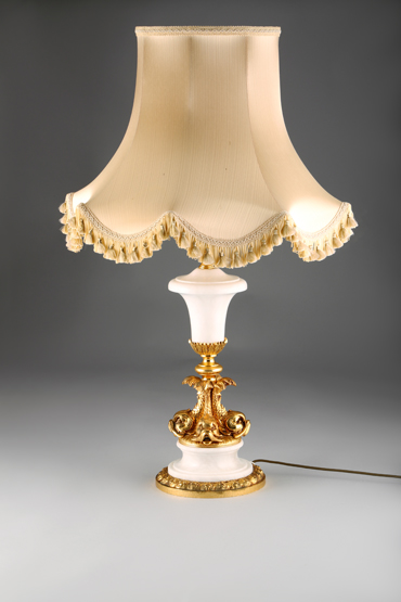 Gilt metal and white marble table lamp and shade, the column in the form of four dolphins