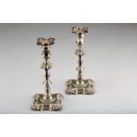 Pair of George II silver candlesticks, engraved family crest, assay marked London, John Café 38ozs