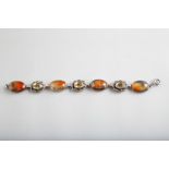 Scottish Silver bracelet set with three citrine interspaced between four polished agates, approx.