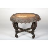 Burmese carved hardwood table, oval top with heavily carved and pierced frieze of foliage and birds,