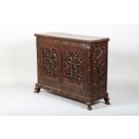 19th/20th Century Burmese cabinet, carved frieze over twin foliate carved and pierced cabinet doors,