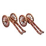 A PAIR OF NORTH EUROPEAN SALUTING CANNON CARRIAGES, 17TH CENTURY of iron-clad repainted wood,