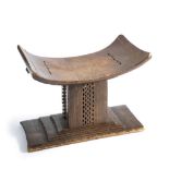 A CARVED AFRICAN STOOL OF ASHANTI TYPE AND A HIDE BUCKET, LATE 19TH/20TH CENTURY the first with