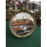 A circular framed barbola mirror