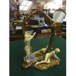 A decorative gilt framed dressing table mirror depicting maidens