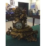 A continental gilt metal mantel clock depicting a gentleman with flute