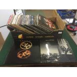 A box of LP records including Genesis, Foreigner,