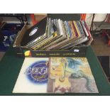 A box of LP records including UB40, Genesis,