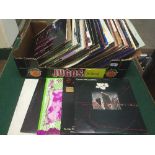 A box of LP records and 2" singles including Robert Palmer,